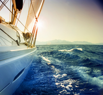 Yacht Sailing against sunset.Sailboat.Sepia toned